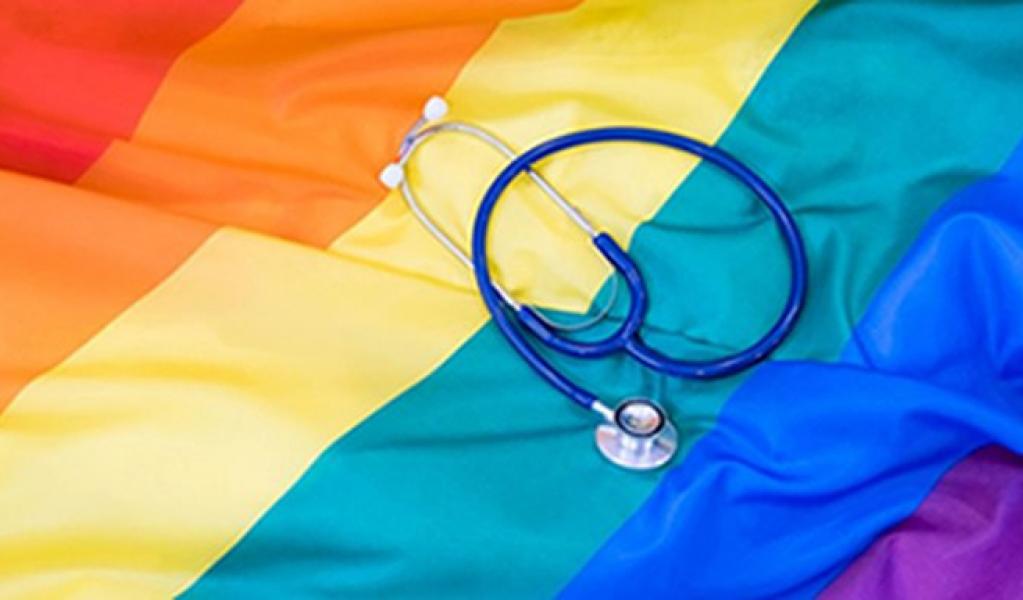 A stethoscope on top of a rainbow flag